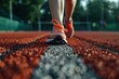 © Pawel - Female athlete preparing to begin a run on an outdoor track, focused on fitness and motivation for a healthy lifestyle and strong cardiovascular training