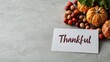 © Nitchalee N. - Thanksgiving celebration and memories, A festive display featuring pumpkins, berries, and a card that reads 'Thankful,' symbolizing gratitude and autumn celebrations.