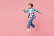 © ViDi Studio - Full body side view young woman wear blue shirt white t-shirt casual clothes jump high run fast hurry up be in rush isolated on plain pastel light pink background studio portrait. Lifestyle concept.