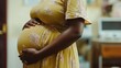 © Chotijah - Pregnant Woman Gently Holding Her Baby Bump