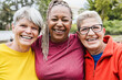 © DisobeyArt - Happy senior women having fun together - Multiracial friends laughing on camera after yoga sport workout outdoor - Main focus on right female face