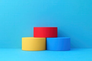 Poster - Three colorful round shapes stacked on a blue background, featuring red, yellow, and blue colors in a minimalist design.