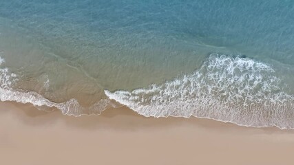 Wall Mural - Aerial drone view of tropical beach waves reaching a sand shore peace coastline