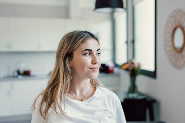 Wall Mural - Head shot close up dreamy young smiling beautiful woman looking away, visualizing future indoors of recollecting good memories. Happy healthy millennial girl enjoying free weekend time at home..