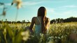 © Felippe Lopes - Young woman sitting in a sunlit field surrounded by wildflowers.
