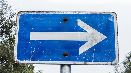 A weathered blue road sign with a white right arrow, indicating direction for drivers.