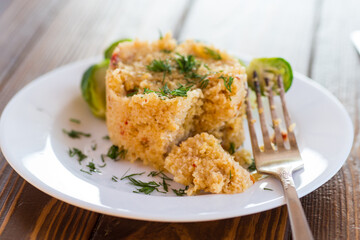 Wall Mural - homemade cooked bulgur with Brussel sprouts in a plate, on a wooden table