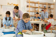 © JackF - Concentrated little girl working at potter's wheel in taller workroom with other circle members