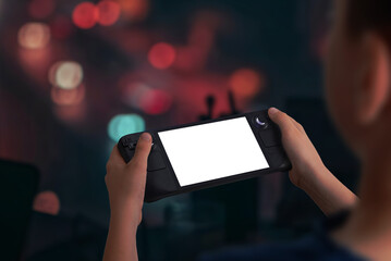 Aufkleber - Boy holding a handheld gaming console playing a game in low light evening setting, perfect for mockup presentations showcasing immersive gaming experiences and design
