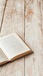 © olegganko - Open book resting on a wooden surface in a cozy reading nook during daylight hours