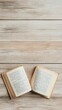 © olegganko - Open book resting on a wooden surface in a cozy reading nook during daylight hours