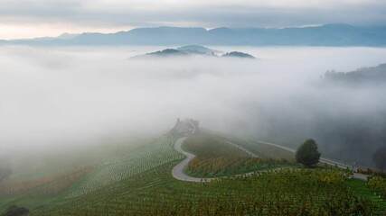 Wall Mural - time-lapse video of morning mists creeping over the picturesque, autumn-covered hills and the famous