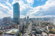 © 수동 김 - A panoramic view of Seoul's skyscrapers, showcasing the bustling cityscape with modern architecture and the flow of traffic in motion.