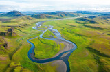 Aerial view of Iceland's glacial rivers and mountains, with intricate patterns of braided waterways