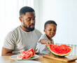 © Lumos sp - child family kitchen food boy son father watermelon fruit slice summer organic meal fun preparing healthy diet eating home black