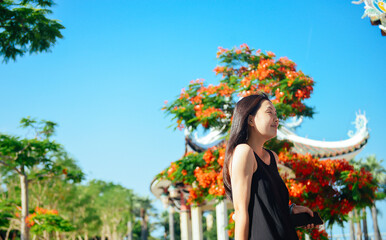 In early June, an Chinese woman is enjoying summer at at JiaGeng Park in Jimei, Xiamen, Fujian, China