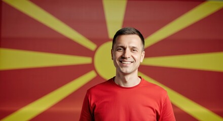 Wall Mural - Smiling man in red shirt with north macedonian flag background for cultural and diversity concept art