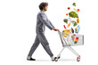© Ljupco Smokovski - Man in pajamas pushing a shopping cart with falling groceries