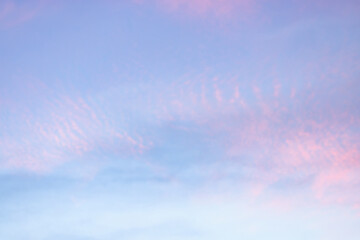 Wall Mural - a beautiful sky tinted by the sun leaving vibrant shades of gold, pink, blue and multicolored. cloud