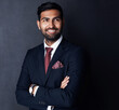 © peopleimages.com - Thinking, crossed arms and happy businessman in studio for career insights, solution and problem solving. Professional, corporate and person for career, job decision and choice on gray background