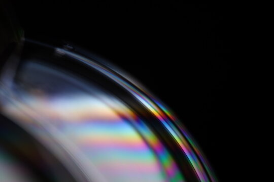 Bright rainbow reflection of liquid in macro, silver colors, surrealistic background, fantastic smooth movement, silver concept, silver ink