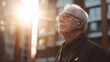 © Lion - Older man in casual attire looking thoughtful outdoors, standing near building with soft sunlight, urban background