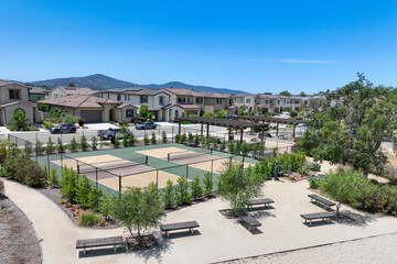 Wall Mural - Aerial view of a pickle ball complex with courts beside a playground in a suburban park in San Diego