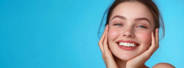 Beautiful woman smiles with white teeth on a blue background.