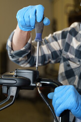 Poster - A technician repairs a device using a screwdriver in a workshop setting
