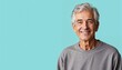 © Yury - Cheerful senior man smiling confidently against turquoise background with copy space