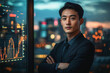 © EJManzaneque - An Asian businessman in a suit standing in front of a large monitor displaying financial data.