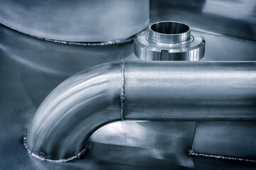 Poster - Dairy machine cooling radiator with a row of stainless steel metal pipes with silver trim. The pipes are connected to each other and appear to be part of a larger system
