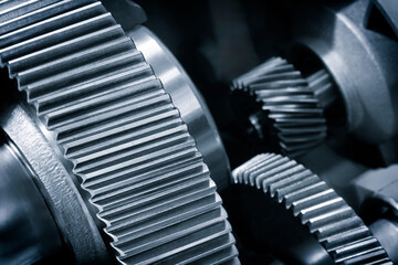 Poster - A close up of a gear with many teeth. The gear is part of a machine and is made of metal in blue