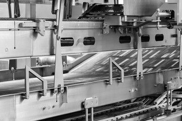 Poster - A conveyor belt with a machine on it. The machine is on the right side of the conveyor belt