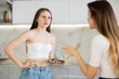© JackF - Two young upset women during quarrel in kitchen at home