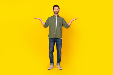 Full length portrait of nice young man hold empty space scales wear shirt isolated on yellow color background