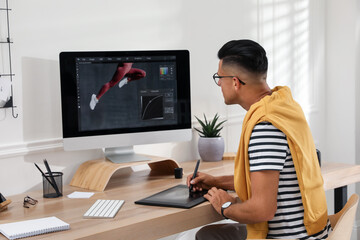 Fototapete - Professional retoucher working on graphic tablet at desk in office