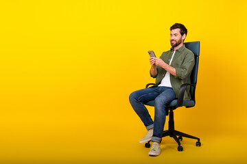 Aufkleber - Full size photo of nice young man sit chair smart phone empty space wear shirt isolated on yellow color background