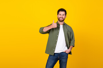 Aufkleber - Portrait of nice young man show thumb up wear khaki shirt isolated on yellow color background