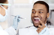 © Prostock-studio - Black Male Patient Showing Aching Tooth During Check Up With Female Dentist, Young African American Man Getting Teeth Treatment With Professional Stomatologist At Modern Clinic, Closeup Shot