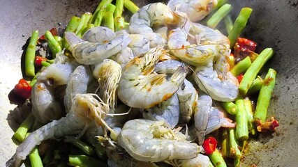 Wall Mural - Frying shrimps with long beans  in pan, in door  Chiangmai  Thailand.