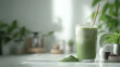 © HQ Assets Project - A refreshing glass of iced matcha latte with a straw sits on a marble countertop, with a pile of matcha powder next to it.