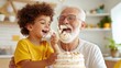 © LifeMedia - A child joyfully applies cake on the face of a laughing grandfather, capturing a humorous and affectionate family moment filled with love and playfulness.