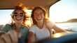© LifeMedia - Two friends are captured laughing with wind-swept hair in a car during sunset, showcasing spontaneity, joy, and the beautiful glow of golden hour light.
