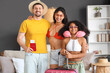 © Pixel-Shot - Happy family with passport and suitcase at home. Travel concept