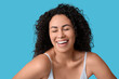 © Pixel-Shot - Beautiful young happy African-American body positive woman in underwear on blue background