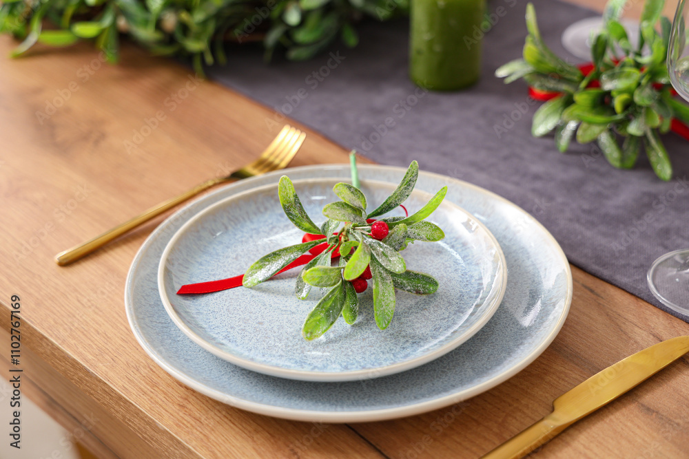 Christmas table setting with mistletoe, closeup