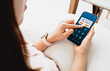 © Ton Photographer4289 - Woman using smartphone to conduct online mobile banking. Business and technology concept
