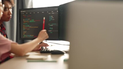 Slow motion back end software developer engineer for computer programming working together on debugging writing computing code, solving complex algorithms display on monitor in office. Burgeoning