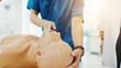 © peopleimages.com - Hands, medical students and first aid for emergency, education and practical training in hospital. People, learning and healthcare in simulation for manikin, knowledge and cpr with dummy in Japan